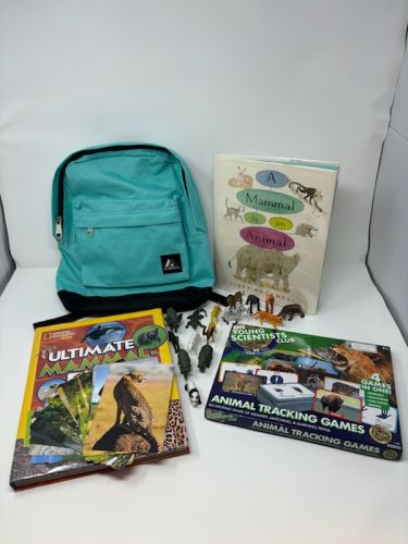 "Zoologist and Mammals" pack on white background with books and animal figurines"