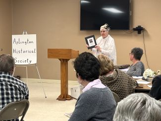 "Janelle Willis presenting Aplington 100 Years presentation." 
