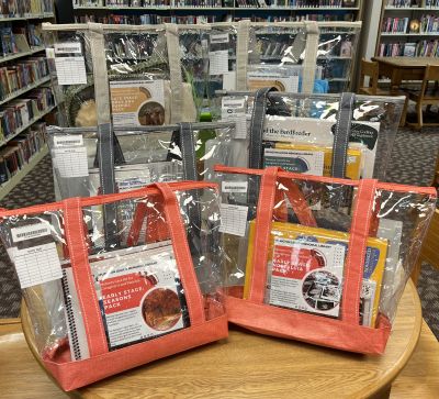 "Six memory care kits in clear bags on wooden table"