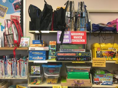"STEM games stacked on shelf on east wall"